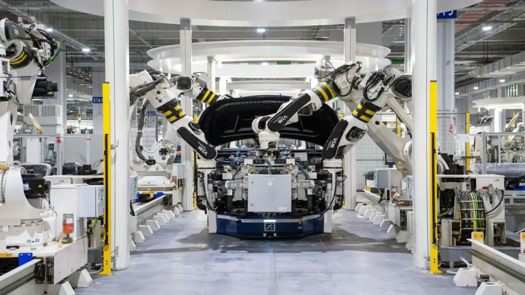 Robotic arms working on vehicle assembly in a high-tech manufacturing facility