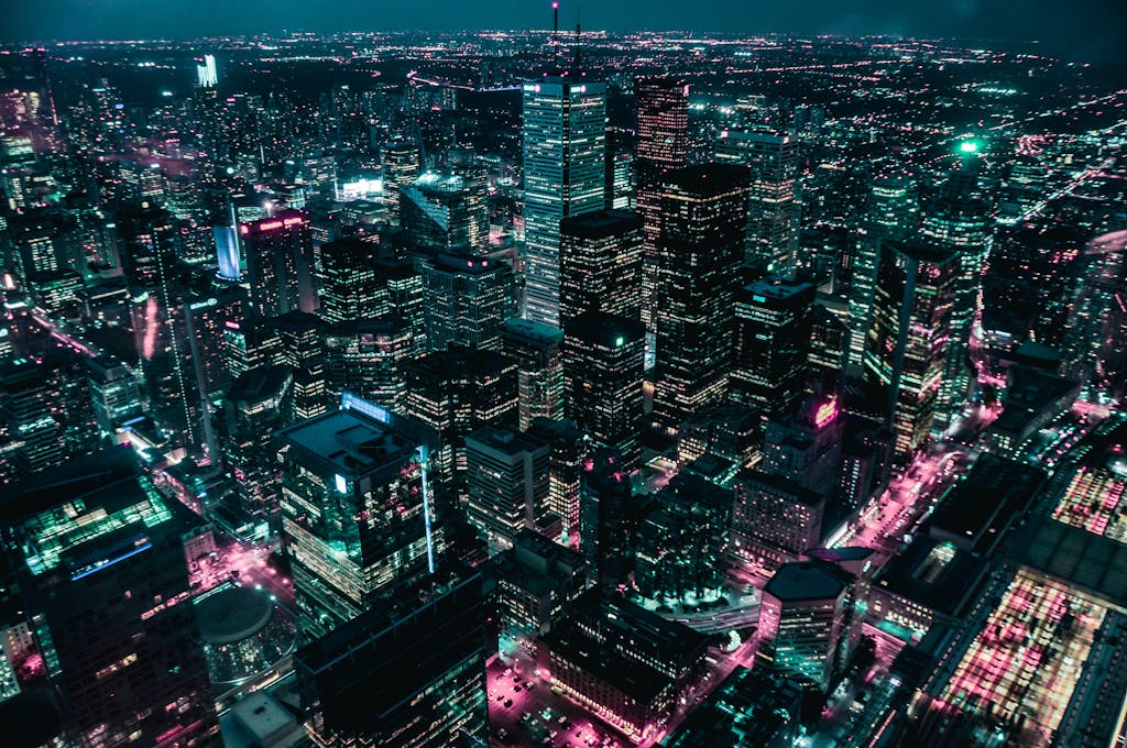 Explore a breathtaking aerial view of a modern city skyline illuminated at night.