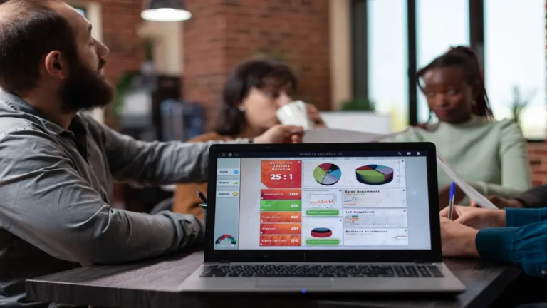 Team meeting with laptop displaying AI financial analytics dashboard for business forecasting and budgeting