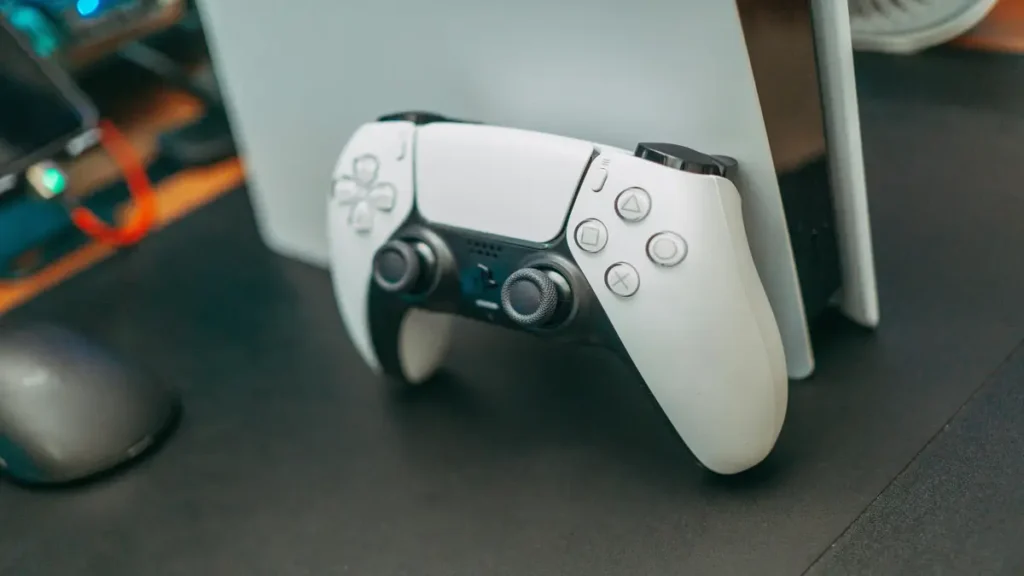 Close-up of a PS5 DualSense controller resting in front of console